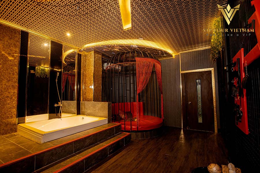 VIP suite with onsen-style bath and a curtained round lounge bed for total privacy.