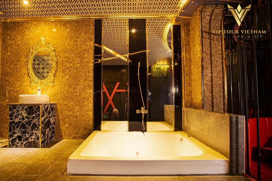 Private room featuring a deep soaking tub framed by steam and shower rooms - your warm-up before Nuru.