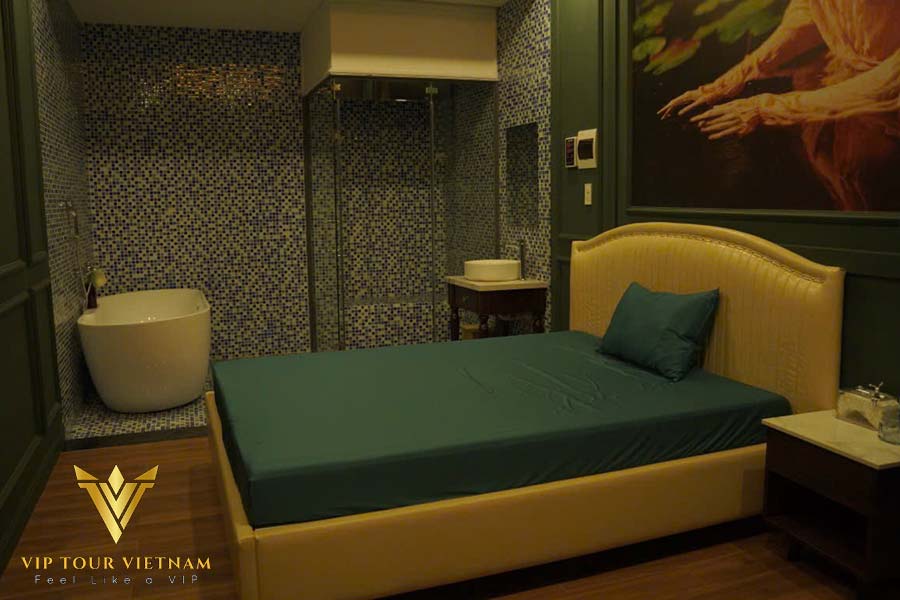 VIP room with king bed, glass shower and freestanding tub.